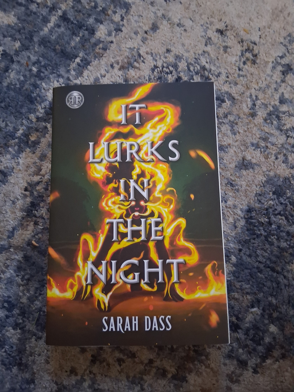 It Lurks in the Night — Sarah Dass (Black with Orange Flame Art)